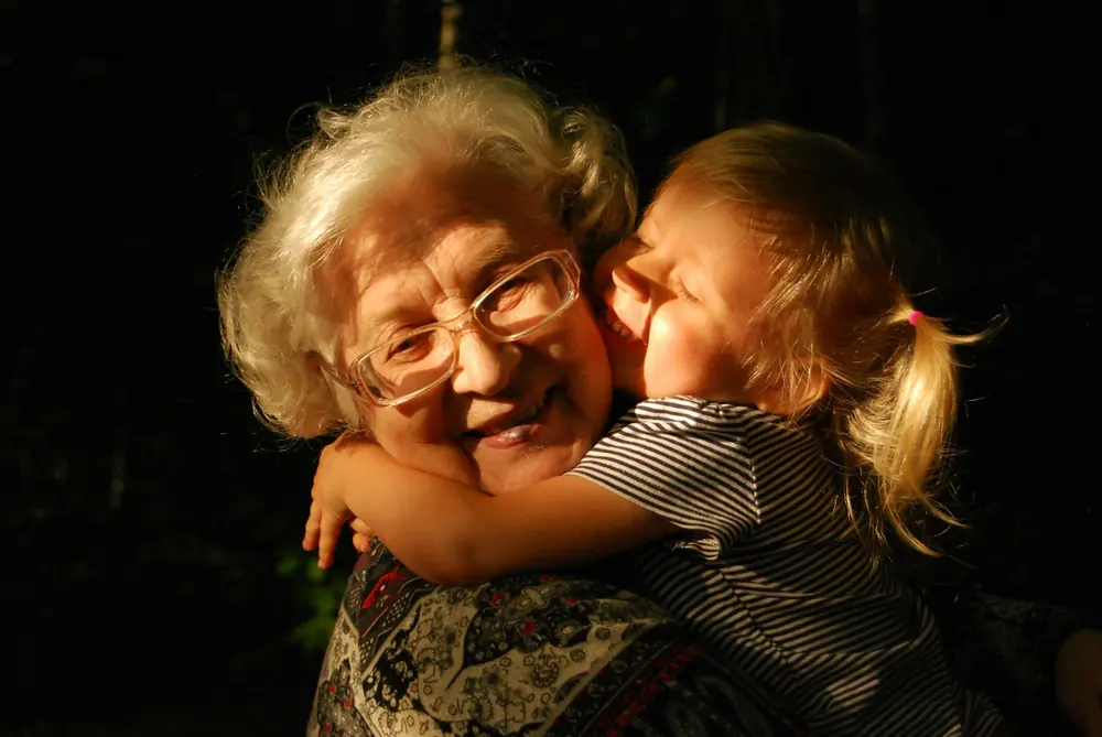 Grandmother hugging her granddaughter