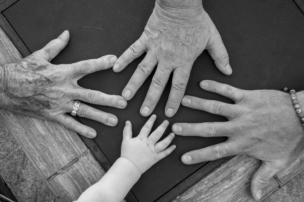 Hands of several generations of a family
