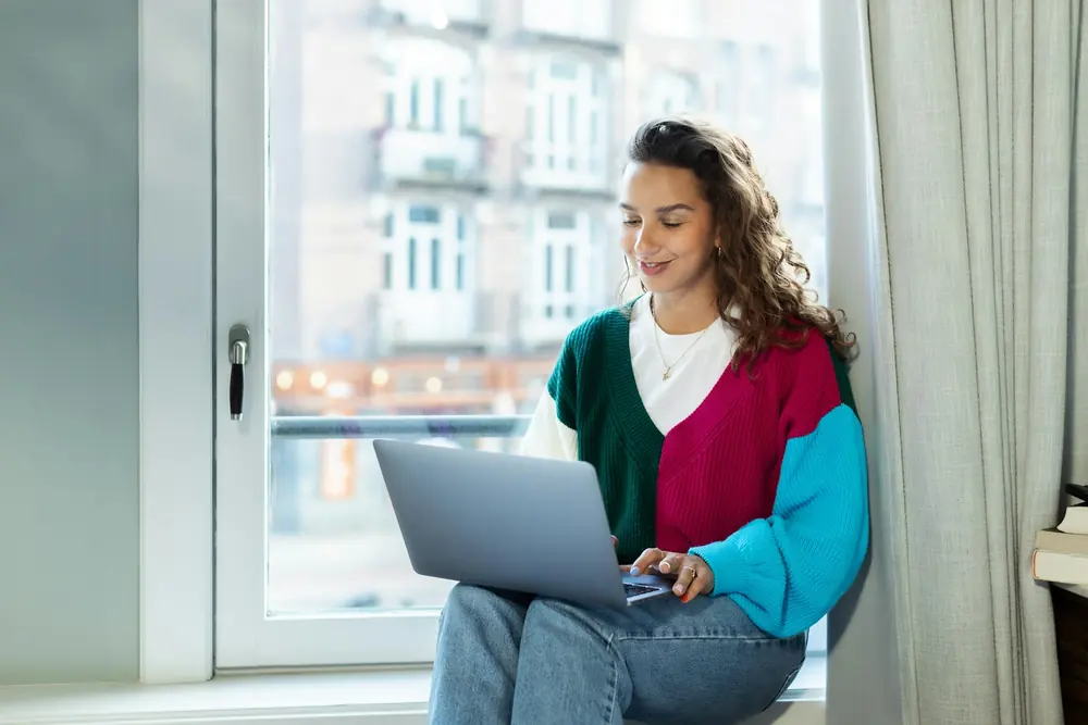 Remote worker by her apartment window